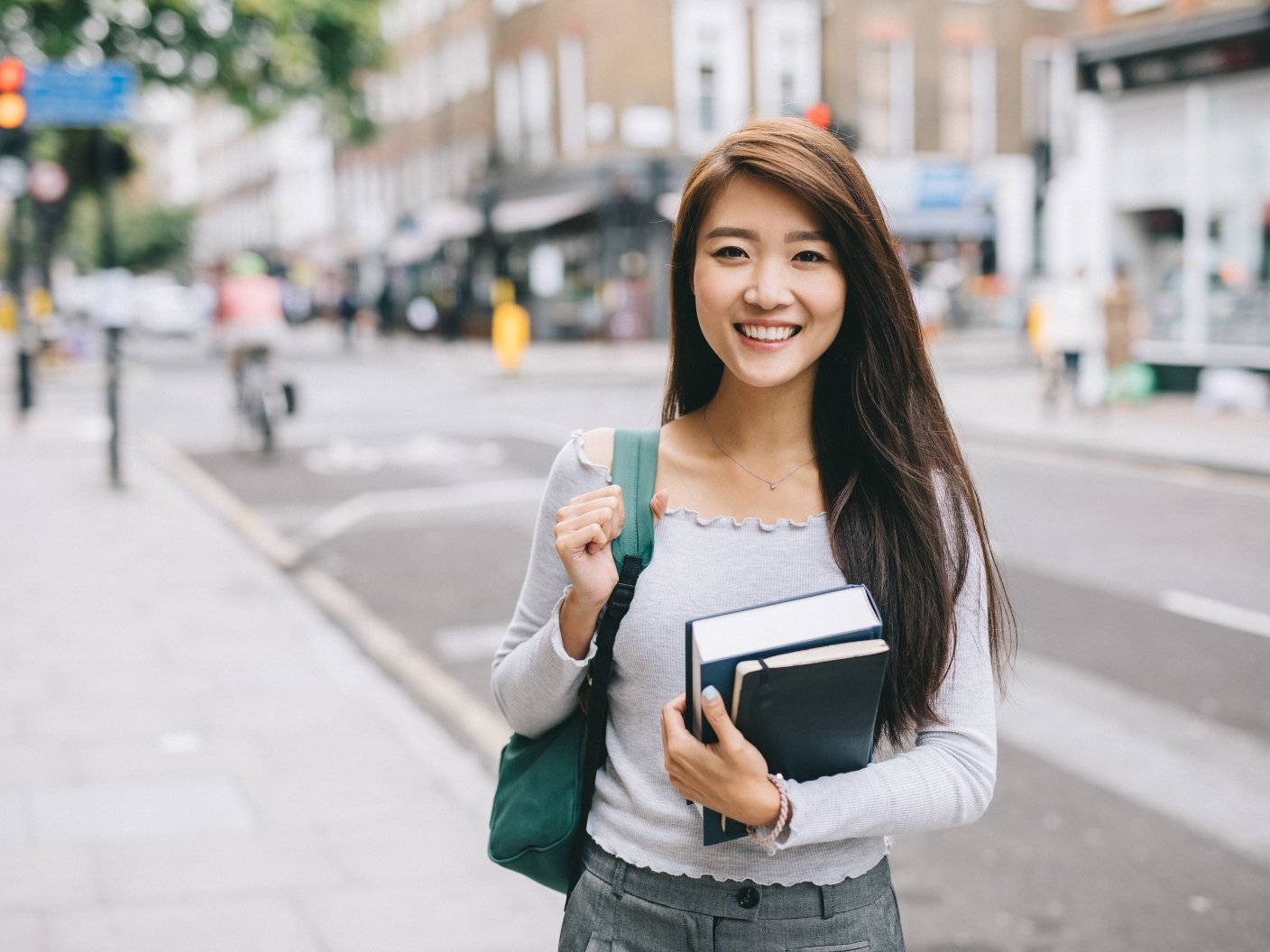 International student smiling outside UK university campus
