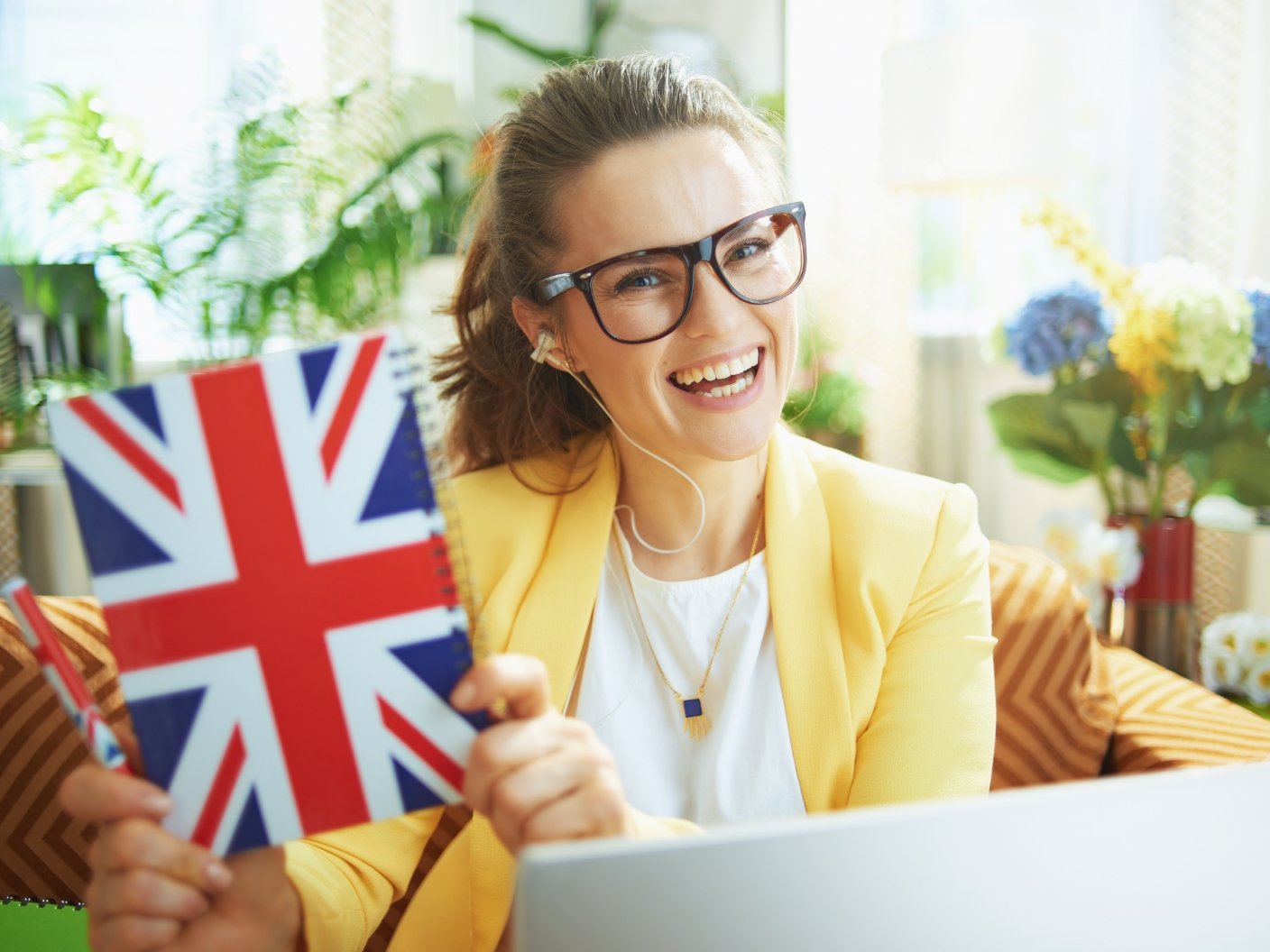 Indian student celebrating UK degree completion with UK flag